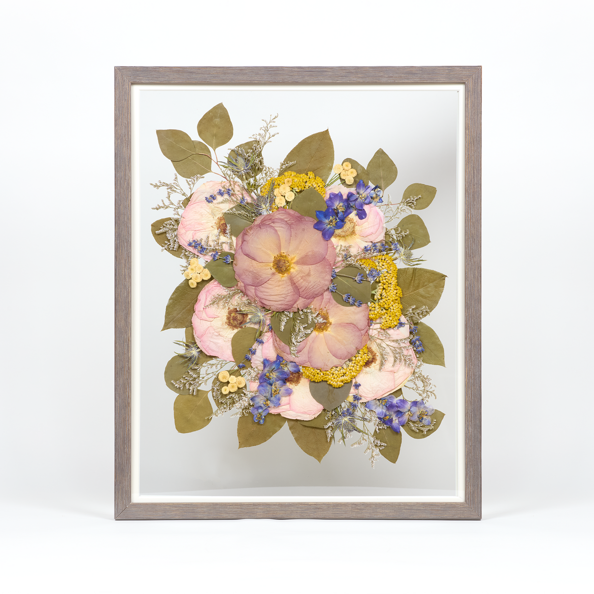 Pressed flower preservation with purple, pink, yellow, and blue florals. Wedding bouquet preservation 16x20 frame in Barn Wood.