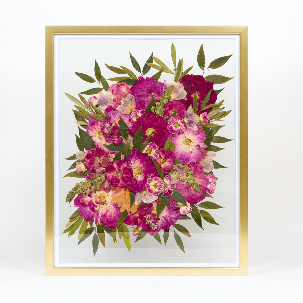 Floral preservation pressed flower frame with bright pink and red pressed florals and greenery. 16x20 gold wood frame design.