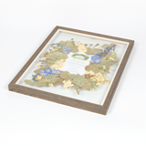 Floral preservation pressed flower frame with white, blue and green pressed florals and an invitation featured in the center. 16x20 barn wood frame design.