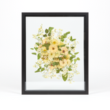 A light and airy floral preservation pressed flower frame with all white and green pressed blooms. 16x20 black wood frame design.