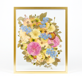 Floral preservation pressed flower frame with pink, white, and blue pressed florals. 16x20 gold wood pressed bridal bouquet frame design.