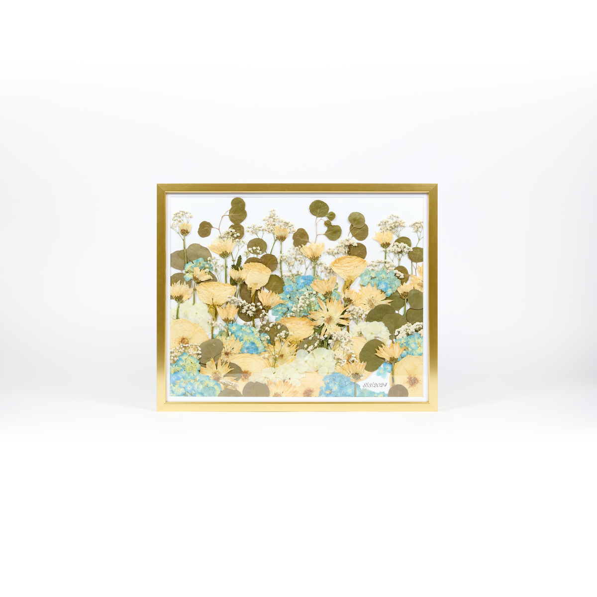 Floral preservation pressed flower frame with a field style design featuring pressed white roses, mums, and blue hydrangeas. 16x20 gold wood frame design.