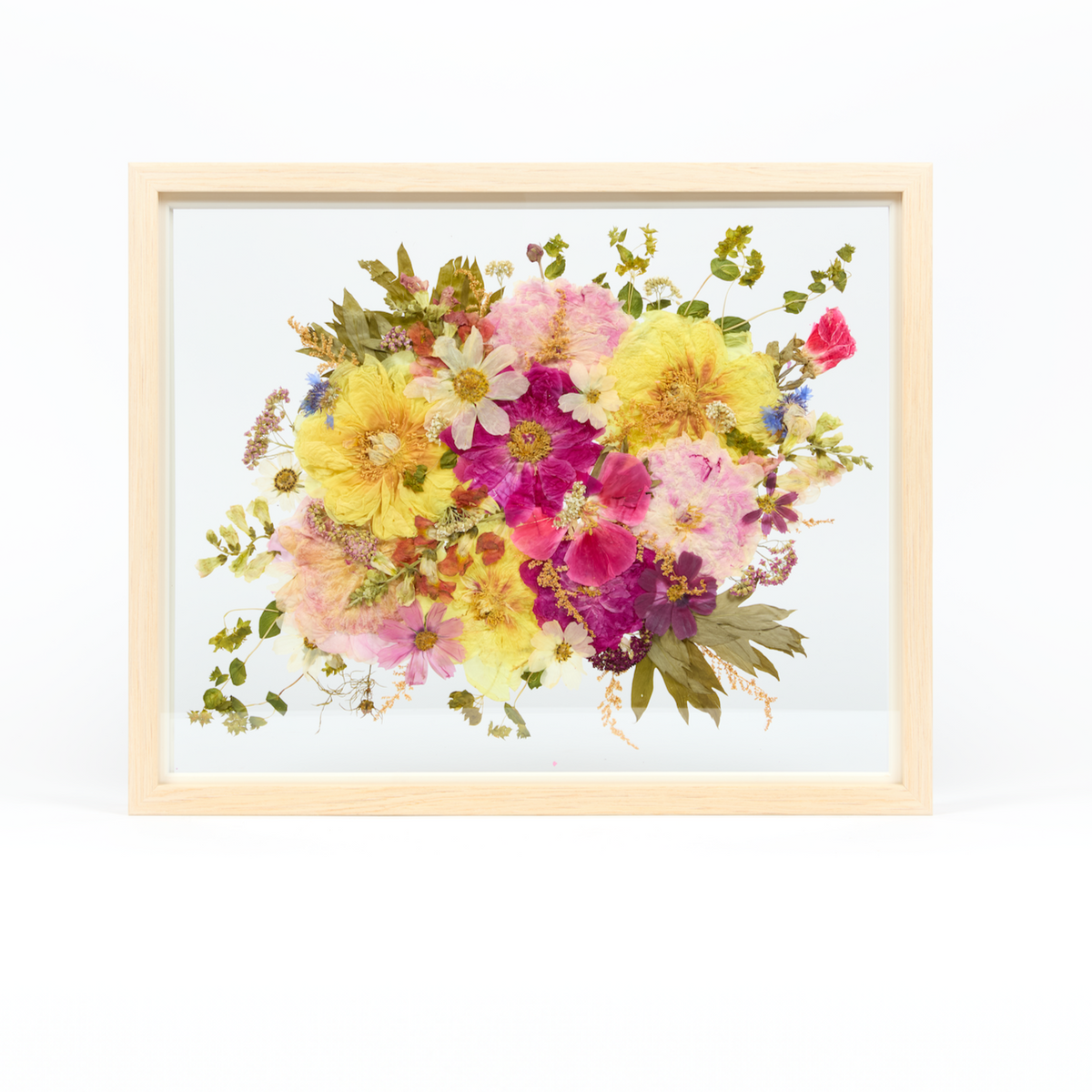 Bridal bouquet preservation in a 16x20 natural wood frame. Pink, white, and yellow pressed florals fill the frame with a floating glass background.