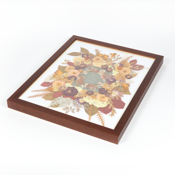 Side view of a floral preservation pressed flower frame with fall-toned pressed florals. 16x20 walnut wood frame bridal bouquet preservation design.