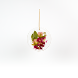Pressed flower resin ornament in a circle shape to as a part of a wedding bouquet preservation order.