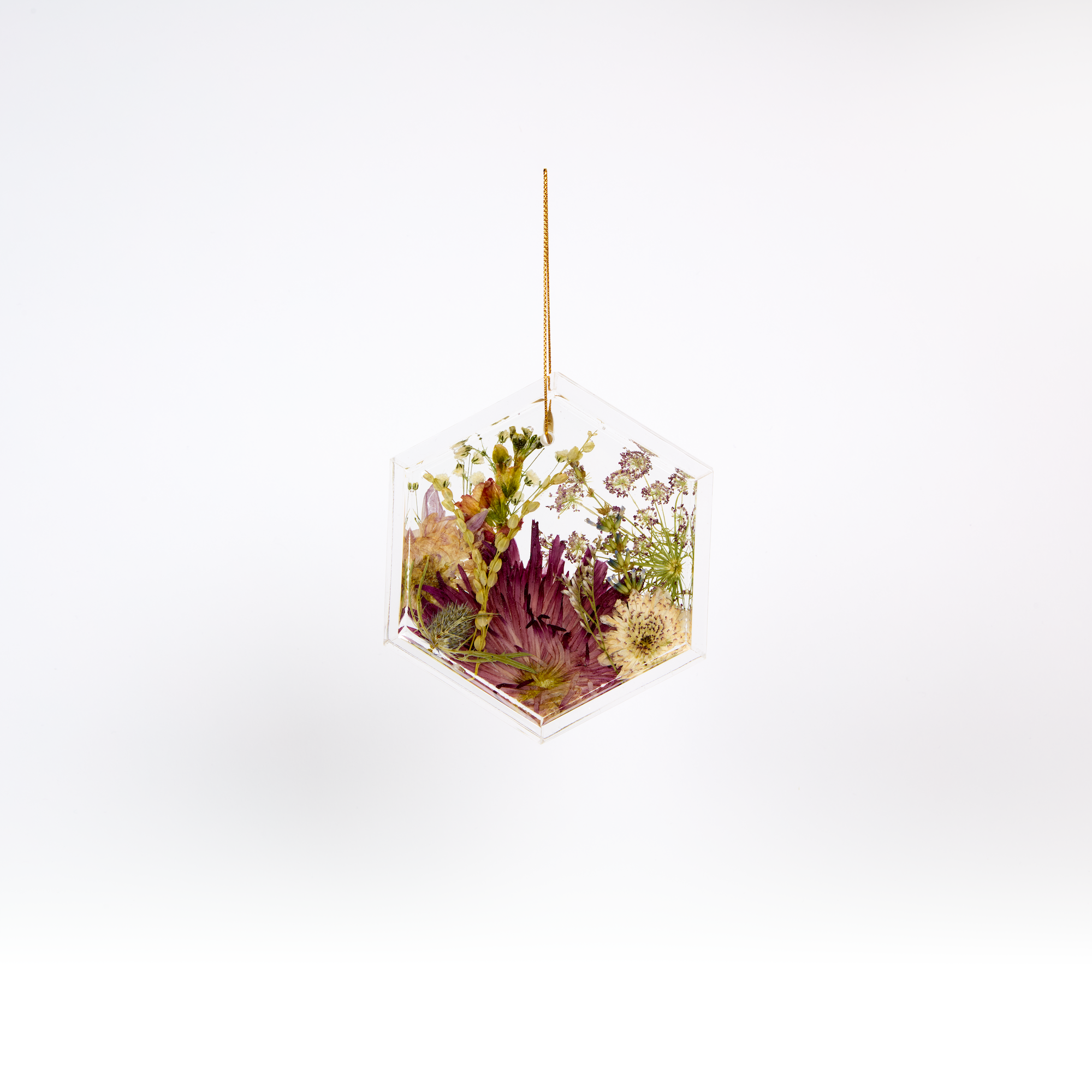 Pressed flower resin ornament in a hexagon shape to as a part of a wedding bouquet preservation order.