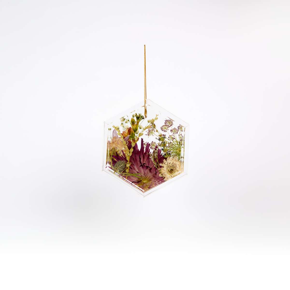 Pressed flower resin ornament in a hexagon shape to as a part of a wedding bouquet preservation order.