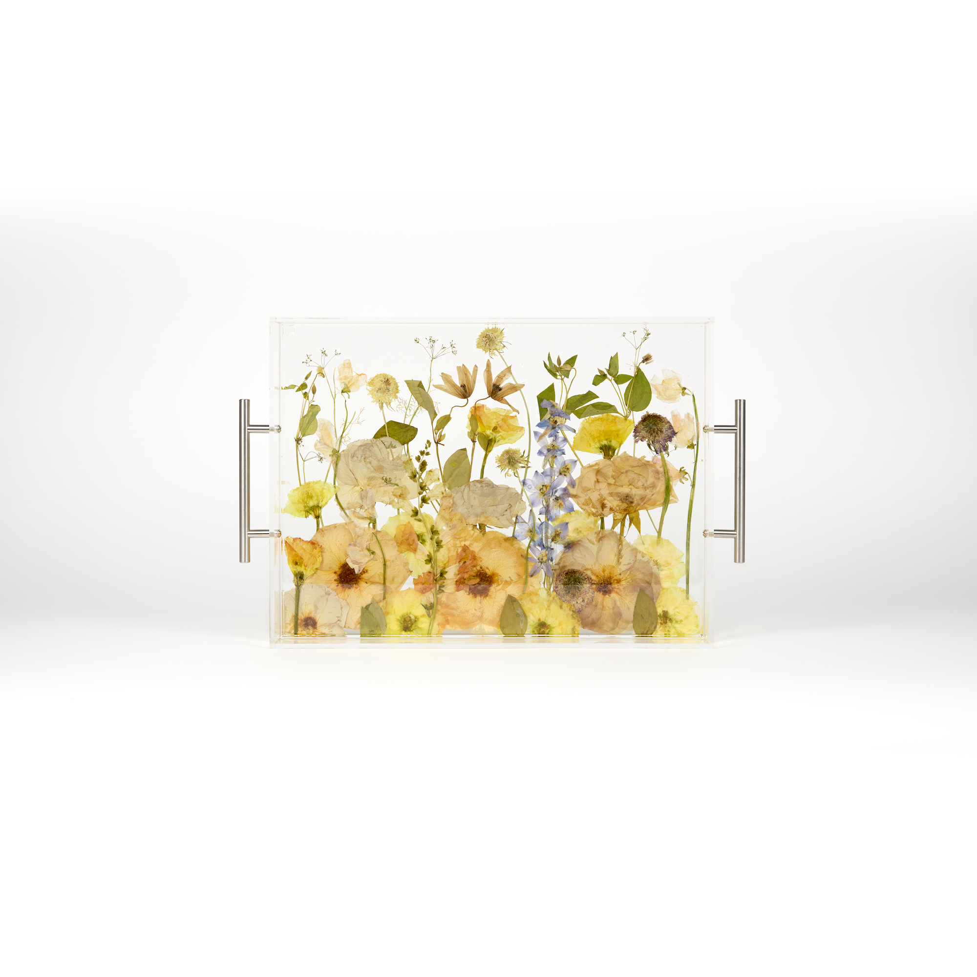 A pressed flower resin serving tray with a field style design. Wedding bouquet preservation as functional home decor.