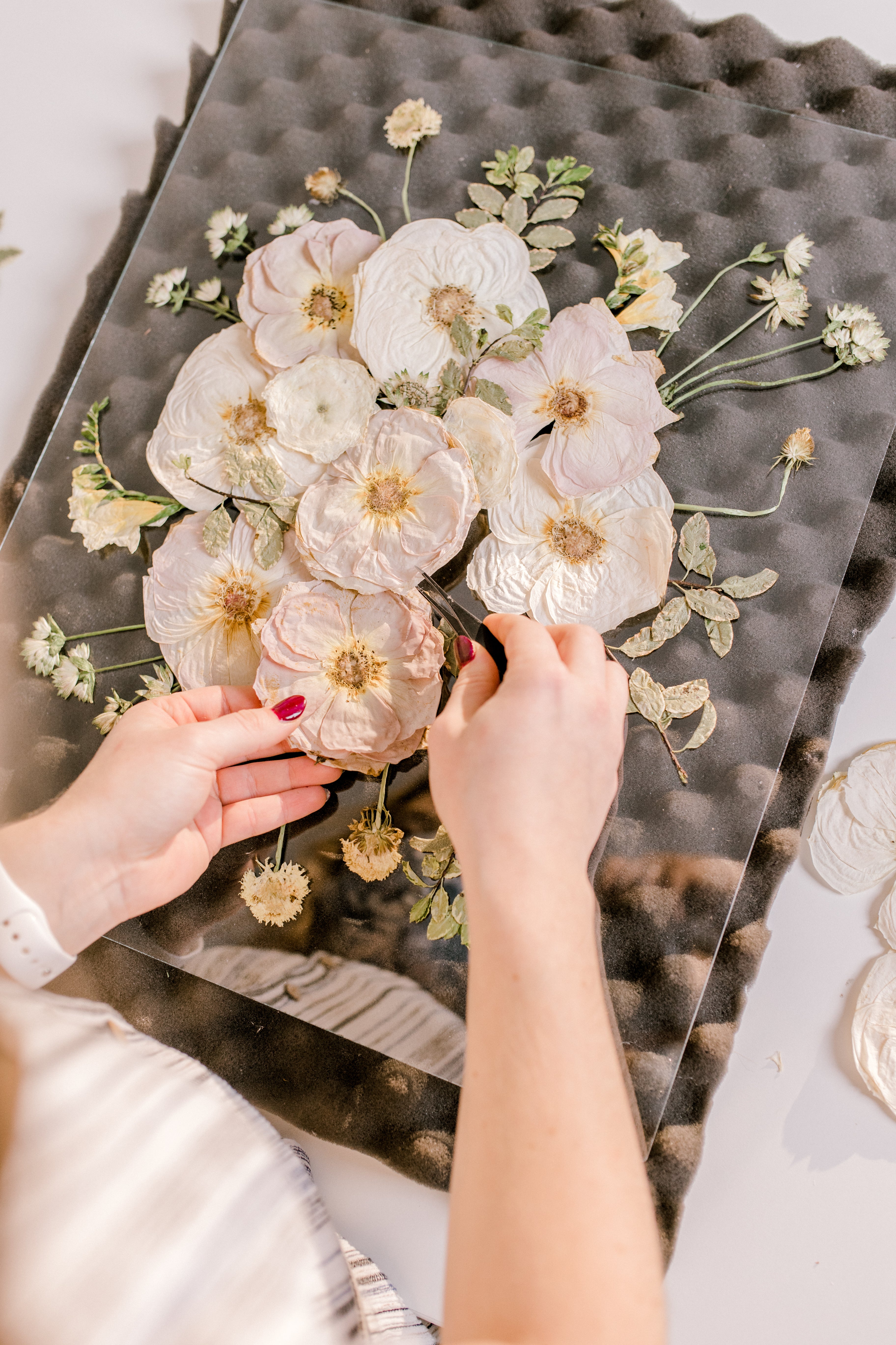 Pressed Bouquet Shop designer organizing a frame design in burst style