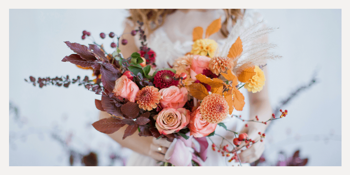 bride holding a fall wedding bouquet