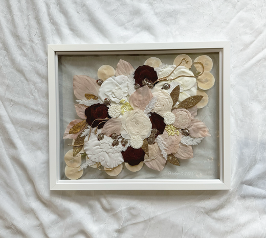 large white frame with pressed fake flowers