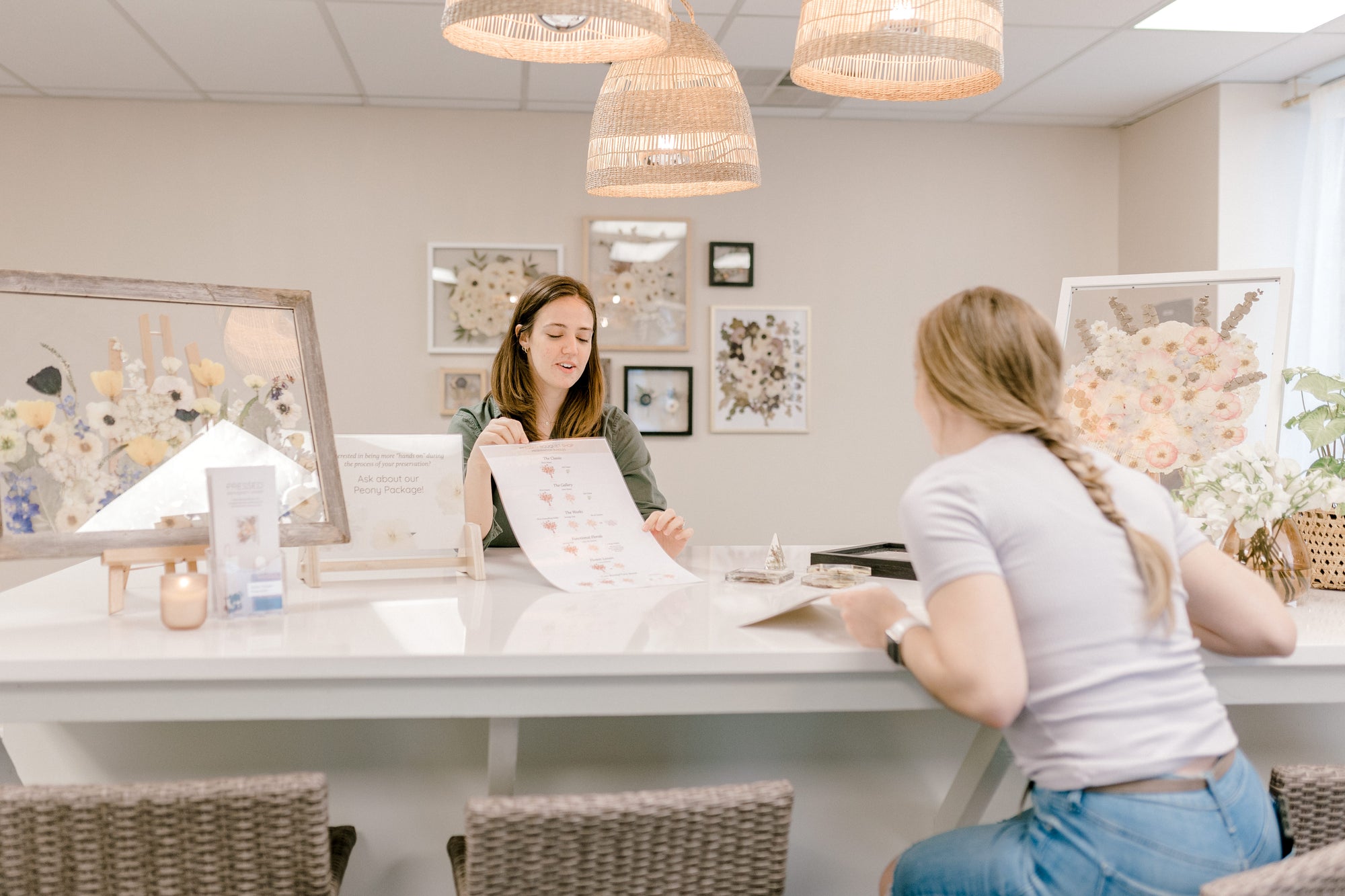 Our client relations manager, Nikole, discussing our ordering guide with a client at an in-person consultation.