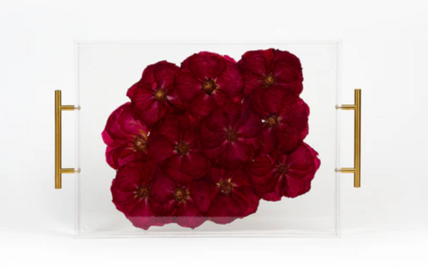 An all red rose bouquet pressed and preserved in a resin flower serving tray with gold handles. 