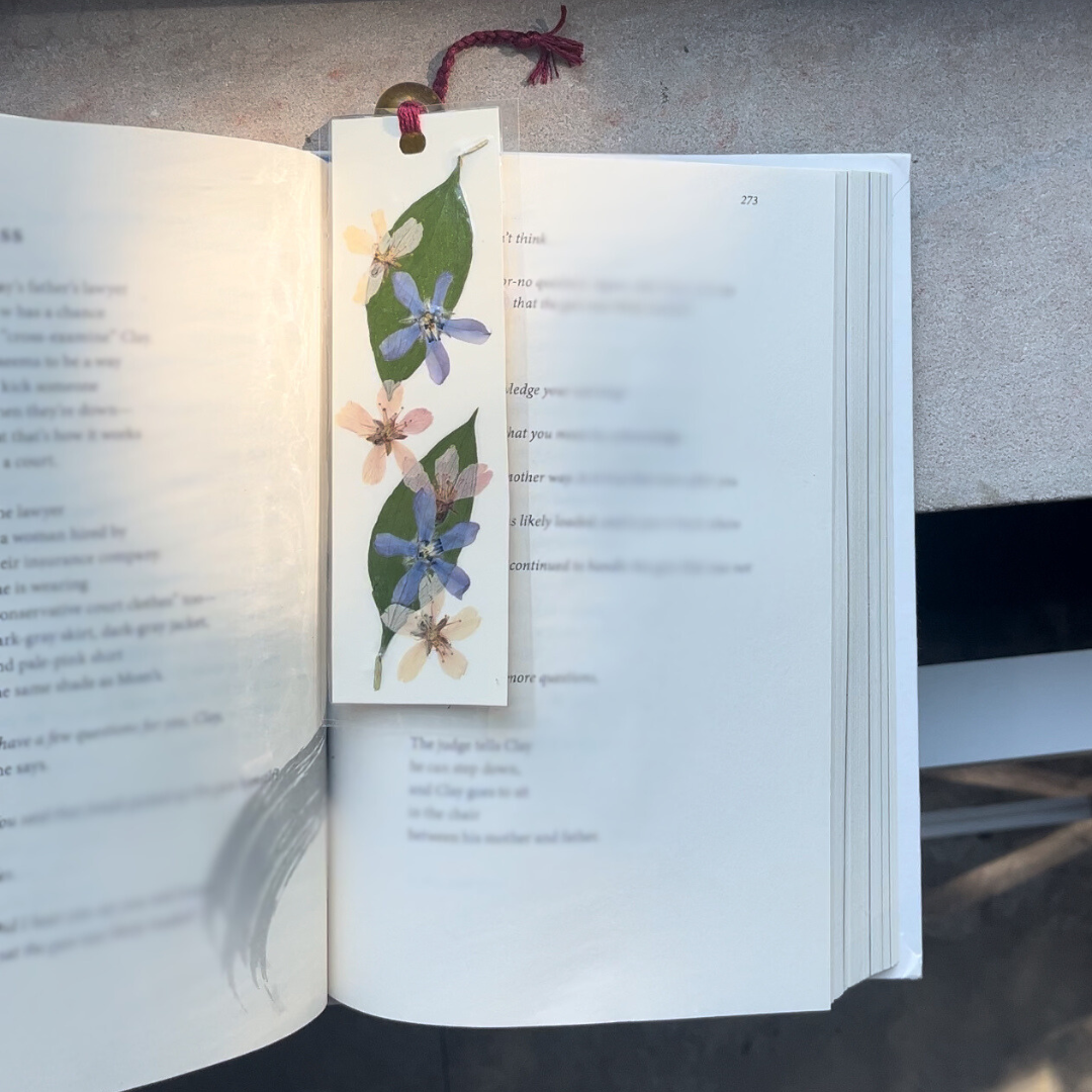 A pressed flower bookmark in a book