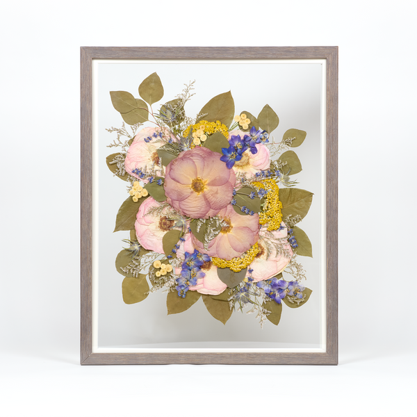 Pressed flower preservation with purple, pink, yellow, and blue florals. Wedding bouquet preservation 16x20 frame in Barn Wood. 