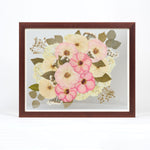 a large walnut colored frame with pink and white pressed florals