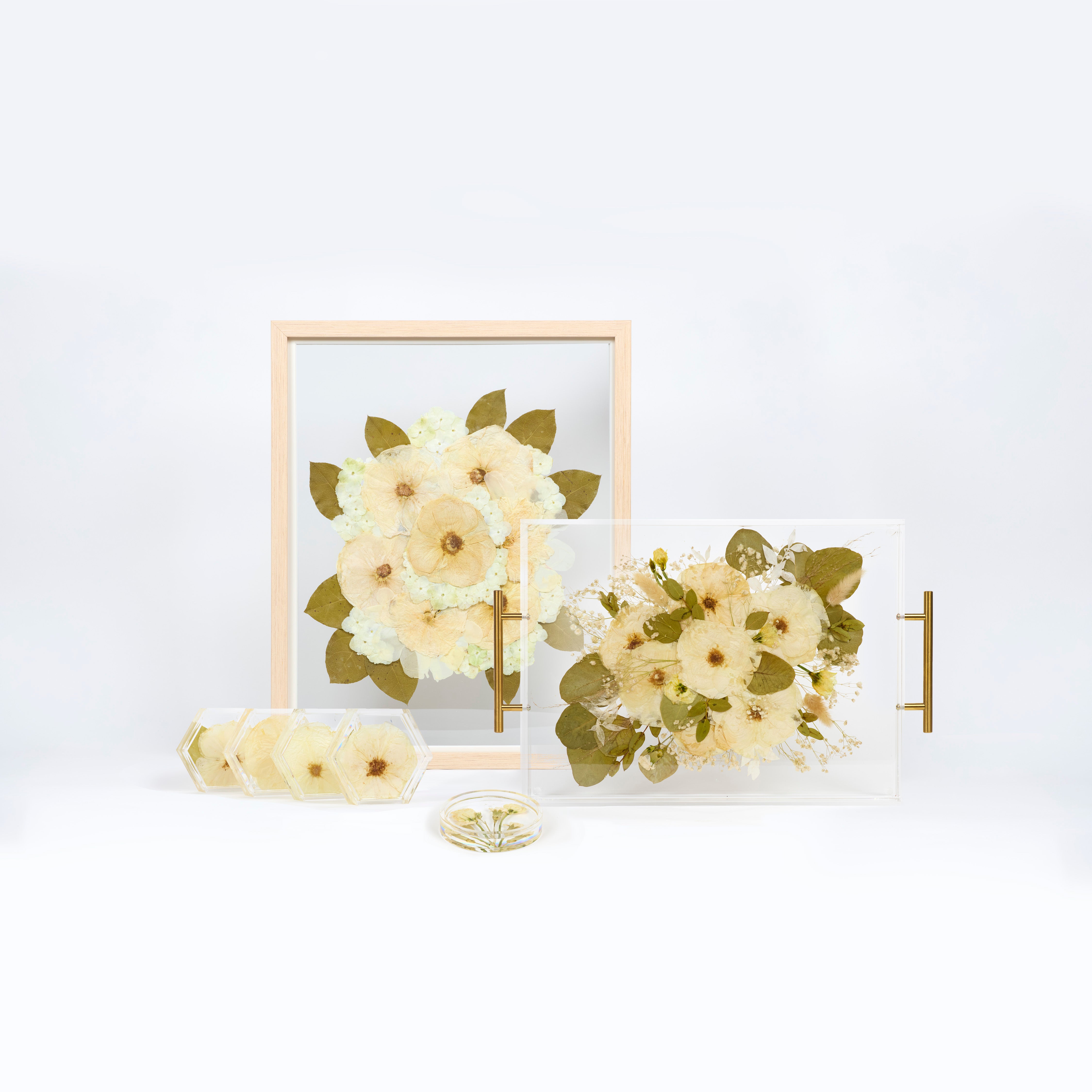 Flower preservation bundle with a pressed floral serving tray, a flower frame, a set of resin floral coasters, and a ring dish. 