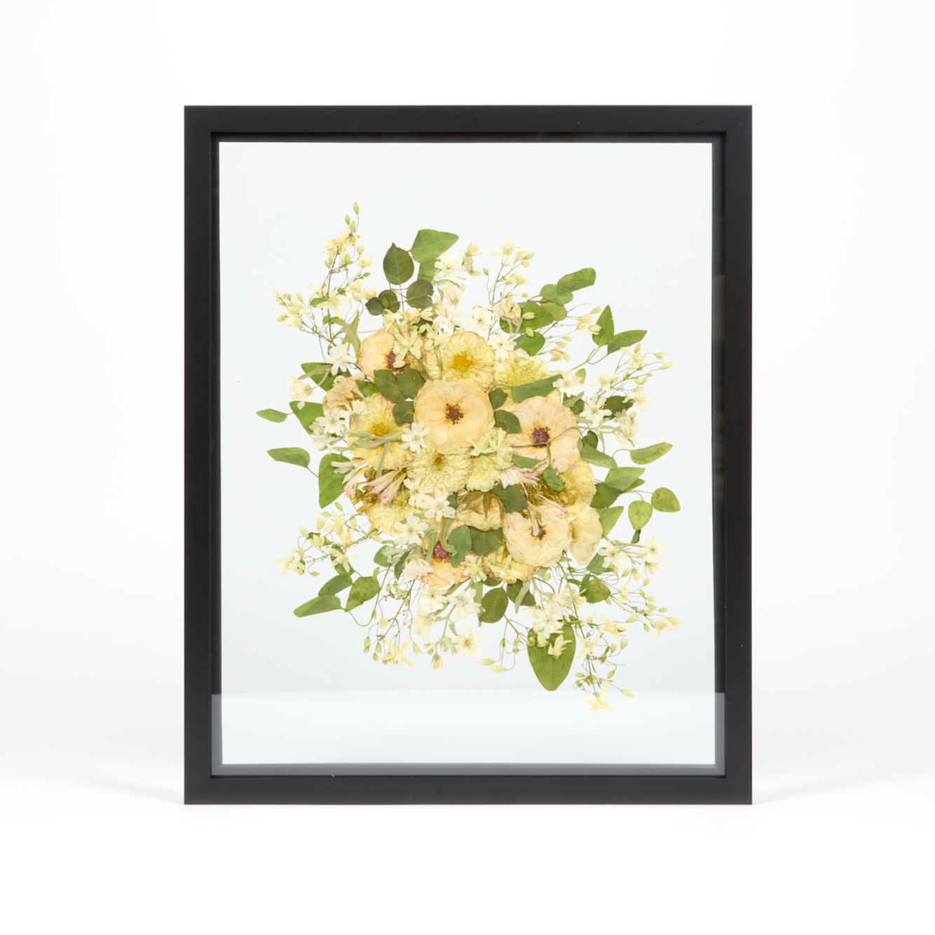 A light and airy floral preservation pressed flower frame with all white and green pressed blooms. 16x20 black wood frame design. 