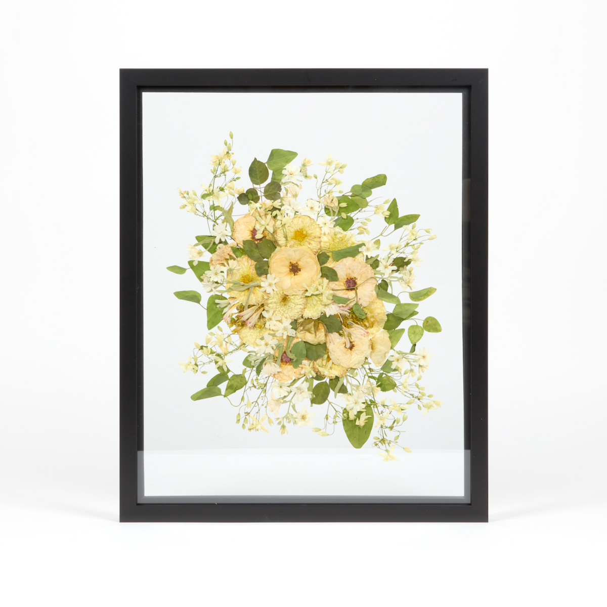 A light and airy floral preservation pressed flower frame with all white and green pressed blooms. 16x20 black wood frame design. 