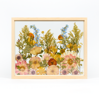 Bridal bouquet preservation in a 16x20 natural wood frame. This field style design with pressed peonies, yarrow, and other garden blooms fill the frame with a floating glass background. 