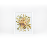 A pressed bridal bouquet in a white wood frame with an archival white background featuring pressed garden blooms such as roses, delphinium, and ranunculus. 