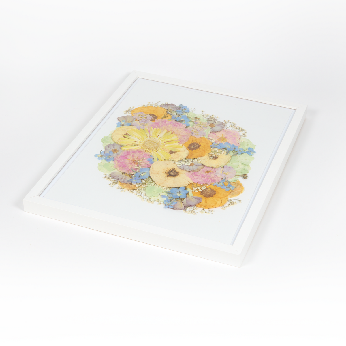 Floral preservation pressed flower frame with vibrant yet soft colored pressed florals. 16x20 white wood frame bridal bouquet preservation design.