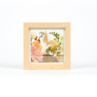 Small flower preservation frame with pink, yellow, and green flowers. 6x6 inch display in a natural wood frame in our field style design.