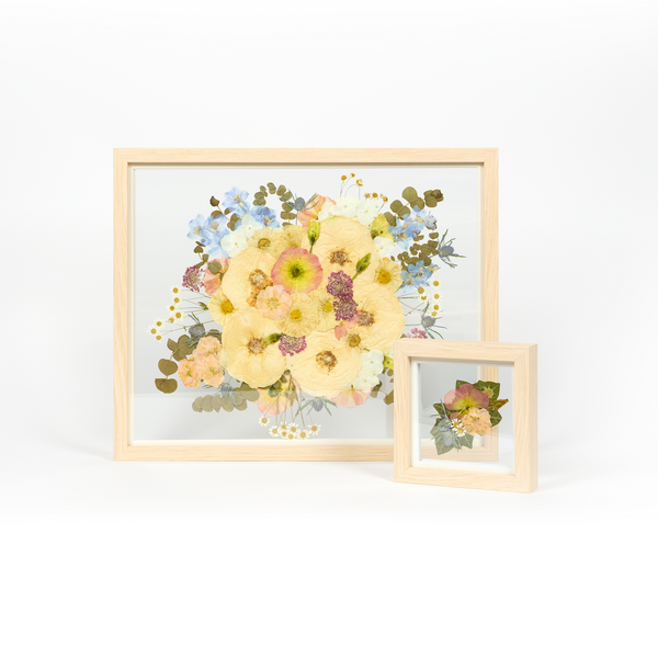 Wedding bouquet preservation set in natural wood with colorful pastel toned pressed florals. 