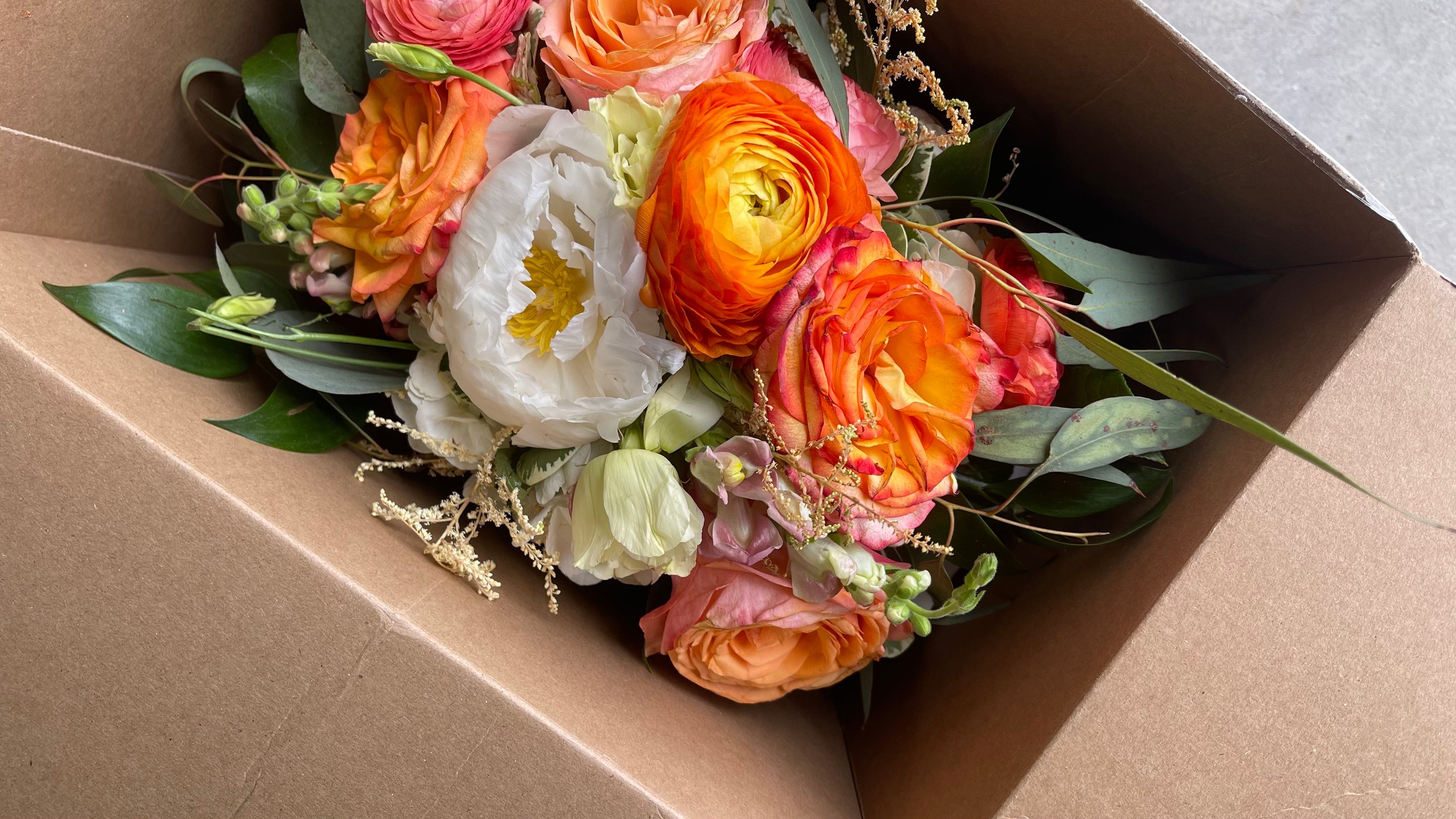 Fresh wedding bouquet in shipping box being sent to the Element Design Co for a wedding preservation keepsake