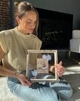 Woman with photograph of baby in a frame with pressed flowers from Element Design Co, Element preservation. 