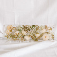 White and green wedding flowers fill a 13x4 inch display tray made out of resin by the Pressed Bouquet Shop.