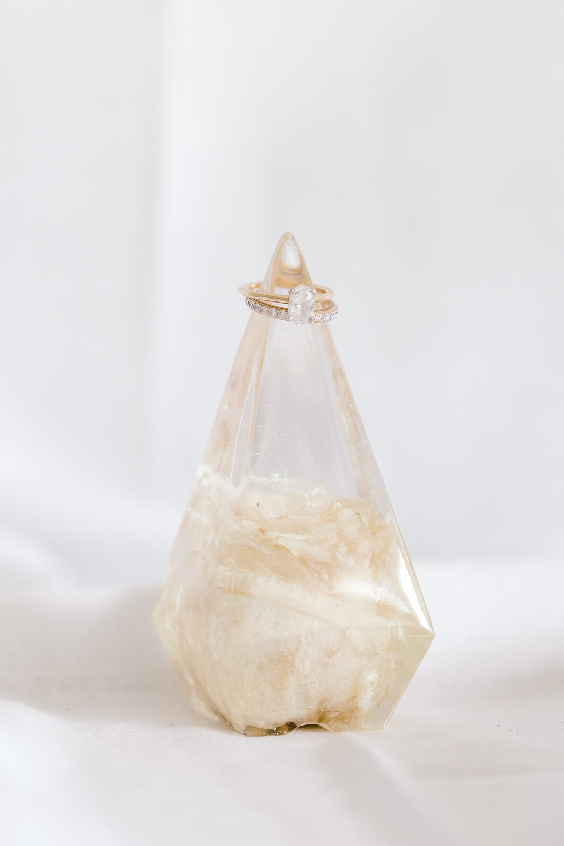 Preserved single white rose in resin in the shape of a ring holder from a wedding.