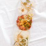 White and orange wedding flowers preserved in resin as a display tray. 