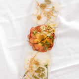 White and orange wedding flowers preserved in resin as a display tray. 