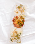 White and orange wedding flowers preserved in resin as a display tray. 