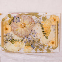 Rectangle resin serving tray with gold handles.