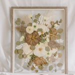 A fall-toned pressed wedding bouquet in a barn wood frame. 