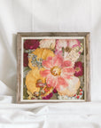 A colorful pressed flower arrangement in a barnwood frame made by the Pressed Bouquet Shop. 