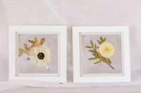 Two 6x6" mini white wood frames with a pressed boutonniere