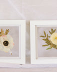 Two 6x6" mini white wood frames with a pressed boutonniere