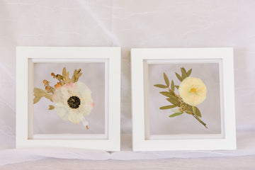 Two 6x6" mini white wood frames with a pressed boutonniere