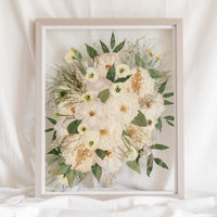 A custom preservation piece made from a wedding bouquet that can be hung on the wall as art. 