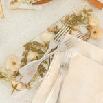 Pressed white and green flowers in a display tray made by the Pressed Bouquet Shop.