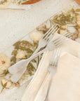 Pressed white and green flowers in a display tray made by the Pressed Bouquet Shop.