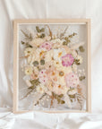 A beautiful wedding bouquet pressed and framed in a natural wood floating frame. 