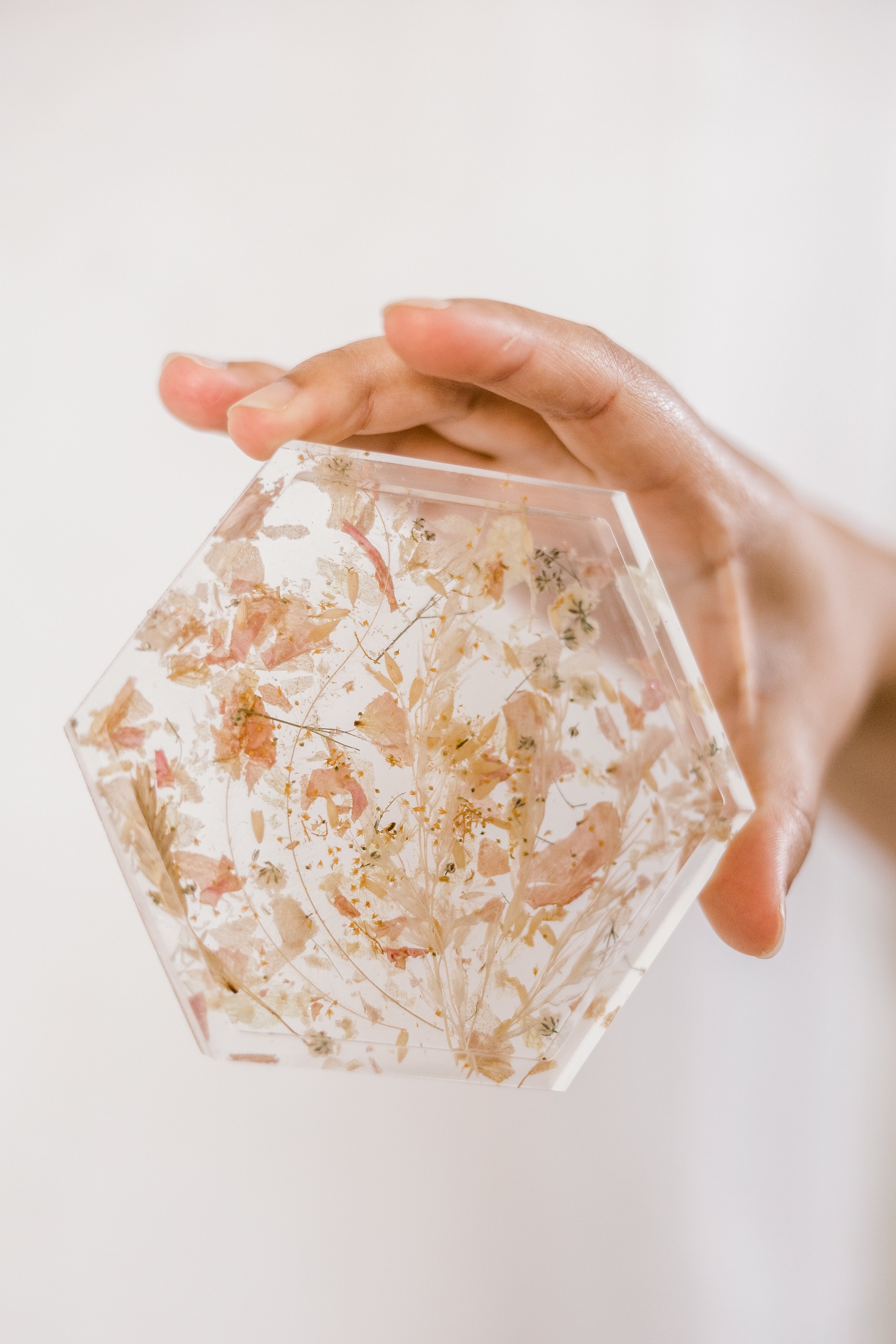 A close-up of a confetti resin hexagon coaster