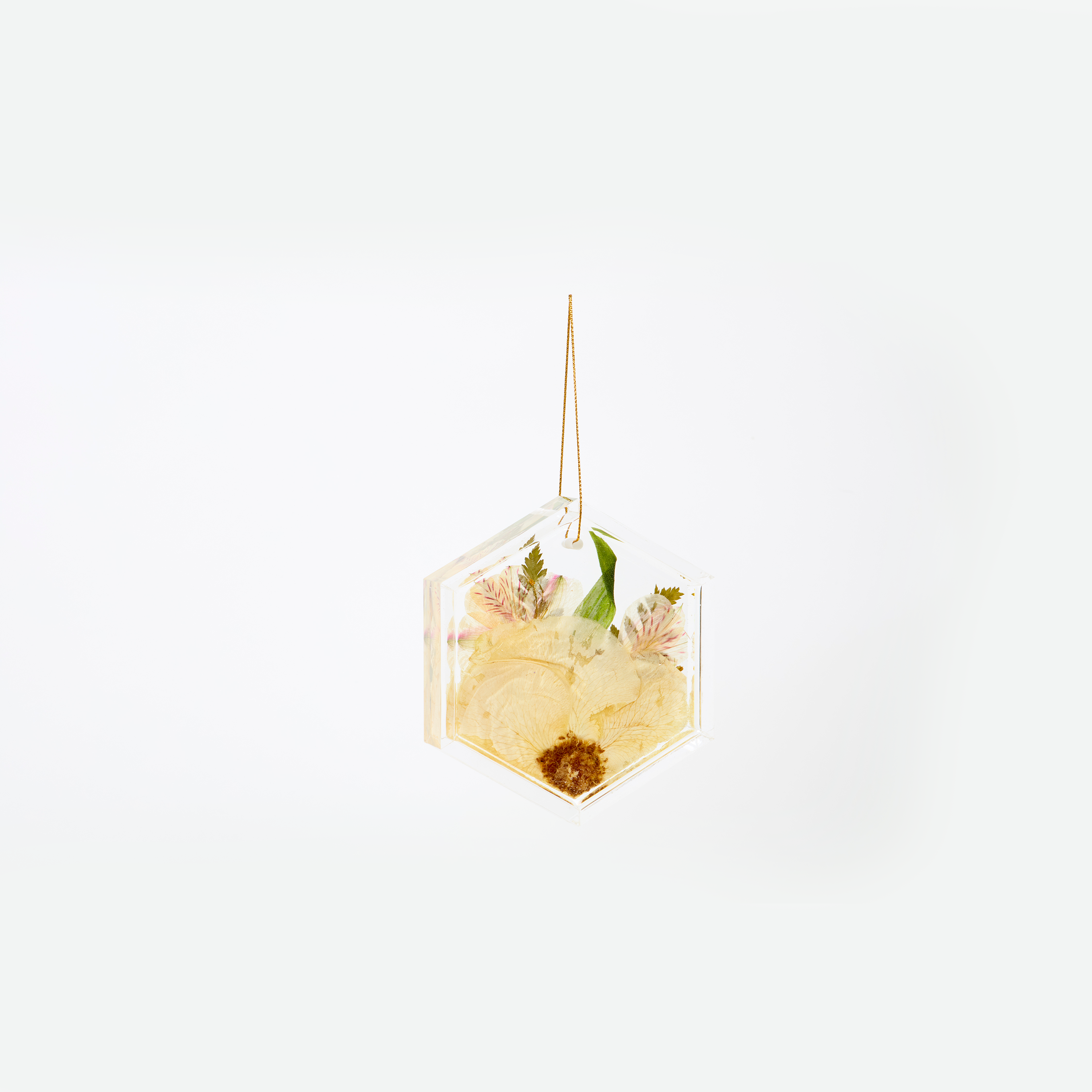 Pressed flower resin ornament in a hexagon shape to as a part of a wedding bouquet preservation order. 