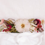 Flowers from a pink and white wedding bouquet preserved as a functional piece of home decor. 