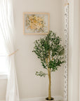 A bouquet of flowers that have been pressed and framed are hung inside of a child's room on the wall. 