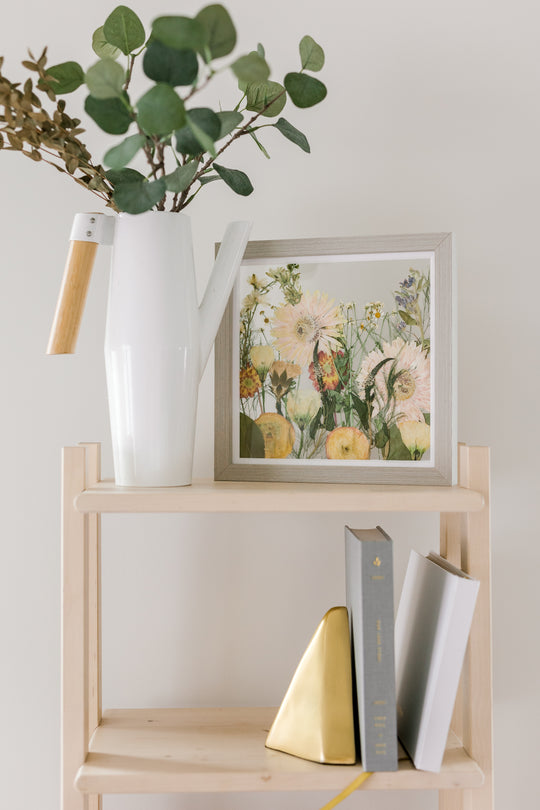Gray 10x10 field style float frame on bookshelf